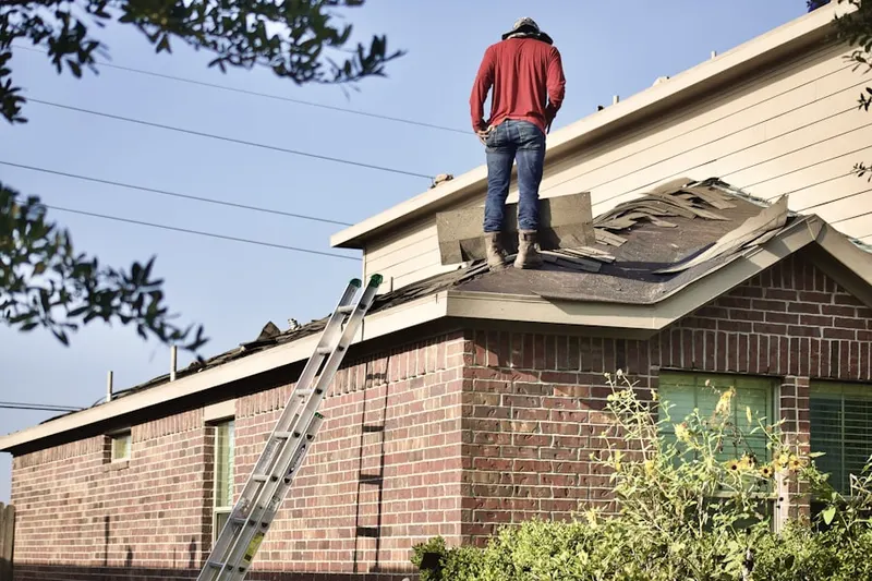 Professional roofer working on a residential roof in Marston
